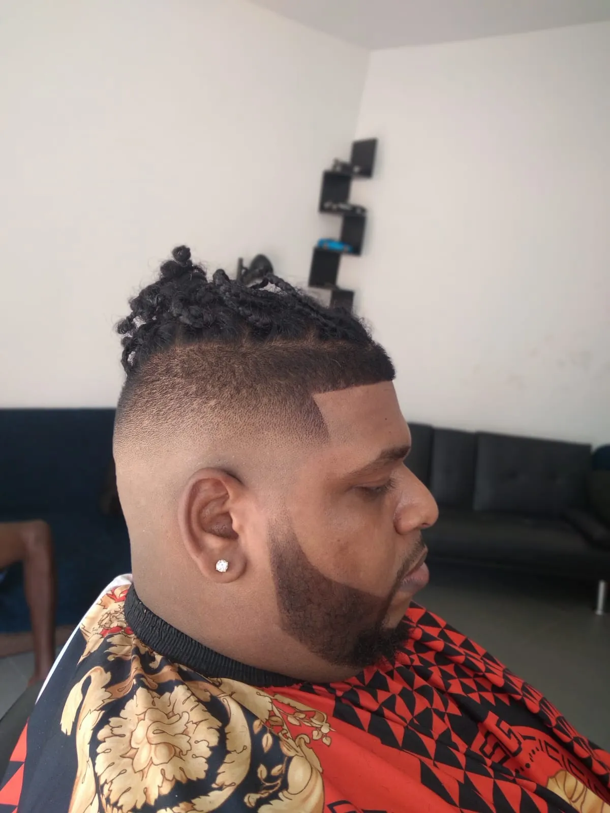 A high skin fade with a sharp line-up and beard, cut by Ryan Cassie in Maraval